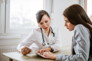 Doctor consulting with patients and considering early intervention of MS diagnosis
